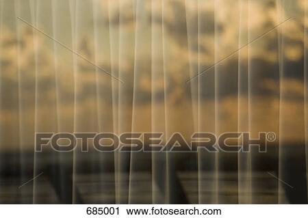 Reflection of a cloudy sky in curtained window pane View Large Photo Image Stock Image - Reflection of a cloudy sky in curtained window pane. Fotosearch