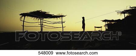 Silhouette of a palapa and a person at dusk View Large Photo Image Stock Photo - Silhouette of a palapa and a person at dusk. Fotosearch