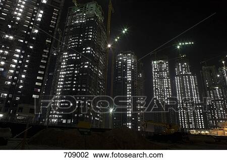 Skyscrapers being constructed at night, Dubai, UAE View Large Photo Image Stock Image - Skyscrapers being constructed at night, Dubai, UAE. Fotosearch