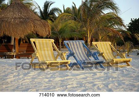 Stock Image - Sun loungers on a beach. Fotosearch