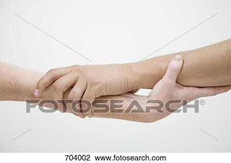 Two hands griping each other's arms, unrecognizable people View Large Photo Image Stock Image - Two hands griping each other's arms, unrecognizable people. Fotosearch