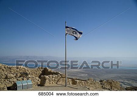 Picture - View of the Dead Sea and an Israeli flag from Masada National Park. Fotosearch
