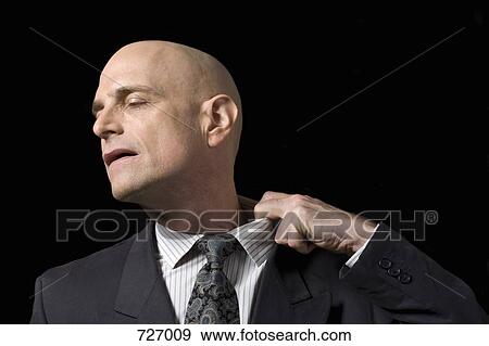 A business man pulling at his collar View Large Photo Image Stock Photo - A business man pulling at his collar. Fotosearch
