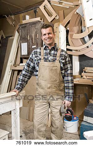 A carpenter standing in a workshop View Large Photo Image Stock Photo - A carpenter standing in a workshop. Fotosearch