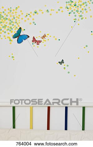 A child's bedroom wall decorated with paint spots and butterflies View Large Photo Image Picture - A child's bedroom wall decorated with paint spots and butterflies. Fotosearch