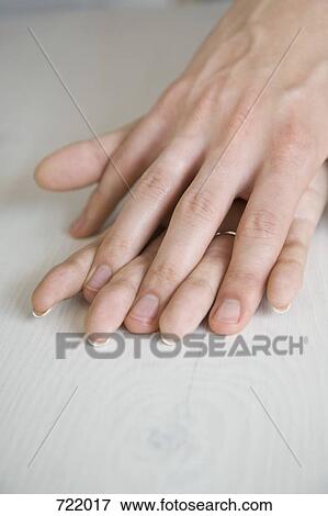 Stock Photo - A couple holding hands. Fotosearch
