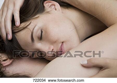 A couple lying down and embracing View Large Photo Image Picture - A couple lying down and embracing. Fotosearch