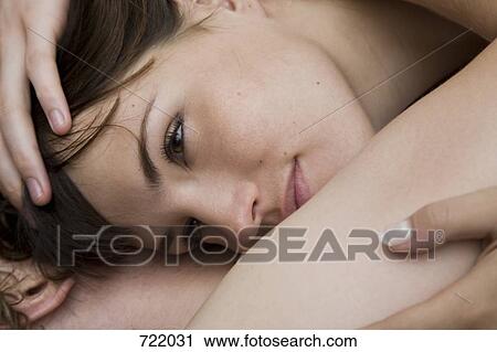 A couple lying down and embracing View Large Photo Image Stock Image - A couple lying down and embracing. Fotosearch