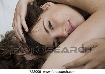 A couple lying down and embracing View Large Photo Image Stock Photography - A couple lying down and embracing. Fotosearch