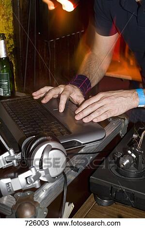 A DJ using his laptop View Large Photo Image Stock Image - A DJ using his laptop. Fotosearch
