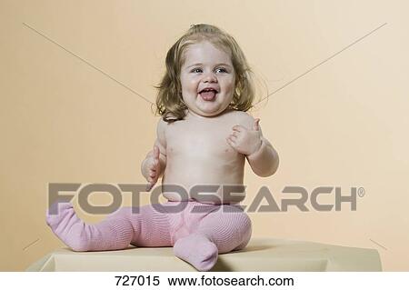 A girl poking her tongue out View Large Photo Image Stock Photography - A girl poking her tongue out. Fotosearch
