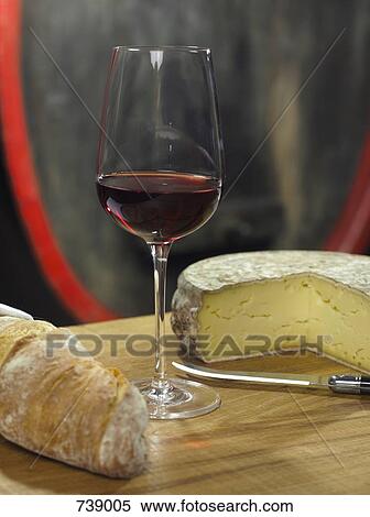 A glass of red wine and a loaf of bread and wheel of cheese, still life View Large Photo Image Stock Photography - A glass of red wine and a loaf of bread and wheel of cheese, still life. Fotosearch