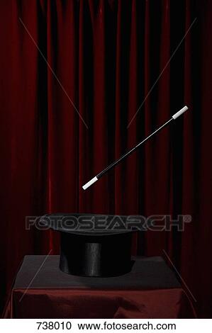 A magic wand hovering over a top hat View Large Photo Image Stock Image - A magic wand hovering over a top hat. Fotosearch