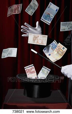 A magician performing magic by making money come out of a hat View Large Photo Image Stock Image - A magician performing magic by making money come out of a hat. Fotosearch