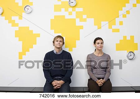 A man and a woman taking a break in an office View Large Photo Image Stock Photograph - A man and a woman taking a break in an office. Fotosearch