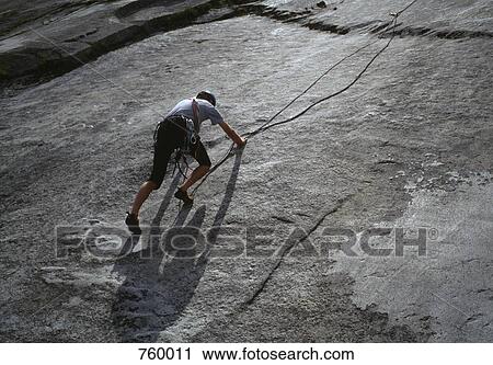 A man climbing a mountain slope View Large Photo Image Stock Image - A man climbing a mountain slope. Fotosearch