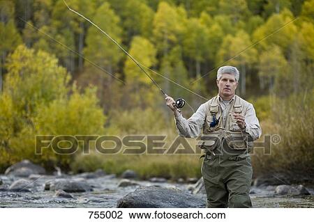 A man fly fishing View Large Photo Image Stock Image - A man fly fishing. Fotosearch