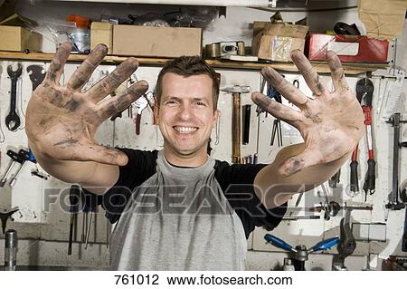 A man holding out dirty hands View Large Photo Image Stock Image - A man holding out dirty hands. Fotosearch