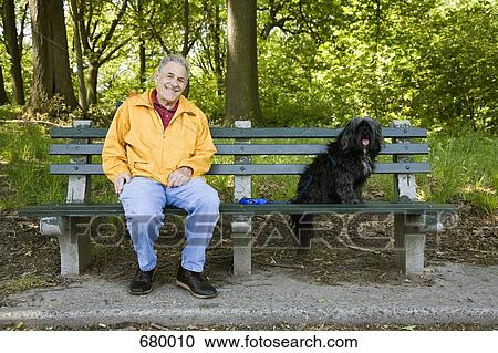 A man sitting with his dog on a park bench, Prospect Park, Brooklyn, New York, USA View Large Photo Image Stock Image - A man sitting with his dog on a park bench, Prospect Park, Brooklyn, New York, USA. Fotosearch