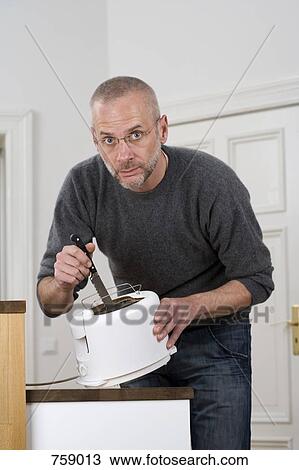 A man sticking a knife in a toaster View Large Photo Image Stock Image - A man sticking a knife in a toaster. Fotosearch