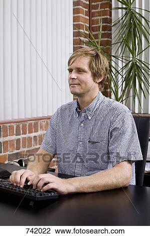 A man typing on a computer keyboard View Large Photo Image Stock Image - A man typing on a computer keyboard. Fotosearch