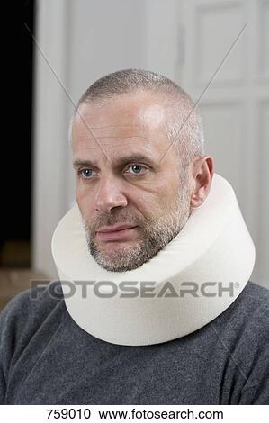 A man wearing a neck brace View Large Photo Image Stock Image - A man wearing a neck brace. Fotosearch