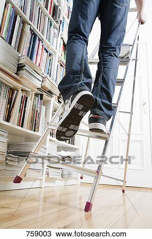 A man's legs climbing up a ladder that's about to tip over View Large Photo Image Stock Image - A man's legs climbing up a ladder that's about to tip over. Fotosearch