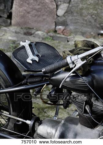 A parked vintage motorcycle with two wrenches on the seat View Large Photo Image Stock Image - A parked vintage motorcycle with two wrenches on the seat. Fotosearch