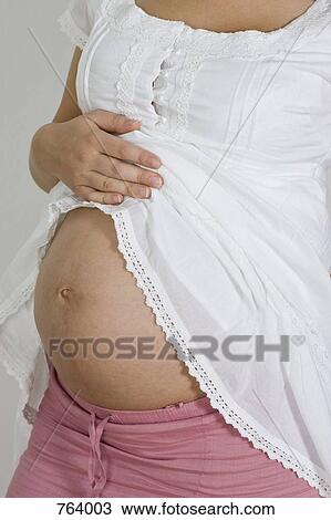A pregnant woman's belly View Large Photo Image Stock Image - A pregnant woman's belly. Fotosearch
