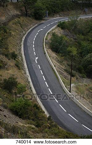 A road curving round a hillside View Large Photo Image Picture - A road curving round a hillside. Fotosearch