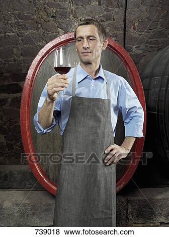 A vintner studying red wine in a glass View Large Photo Image Stock Photo - A vintner studying red wine in a glass. Fotosearch