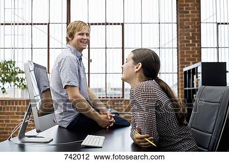 Stock Image - A woman and a man on a break in an office. Fotosearch
