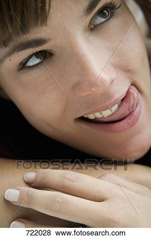 A woman licking her lips View Large Photo Image Stock Photo - A woman licking her lips. Fotosearch