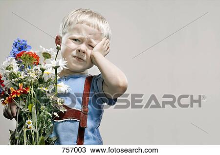 A young boy with a bunch of flowers pouting View Large Photo Image Stock Image - A young boy with a bunch of flowers pouting. Fotosearch