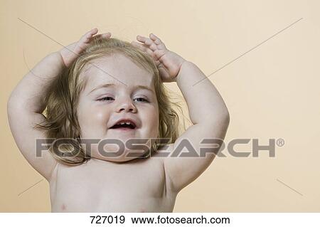 A young girl raising her arms View Large Photo Image Stock Photo - A young girl raising her arms. Fotosearch