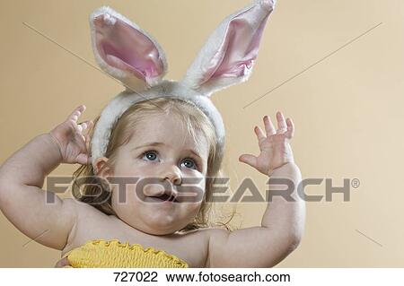 A young girl wearing a rabbit-ear hair band View Large Photo Image Stock Image - A young girl wearing a rabbit-ear hair band. Fotosearch