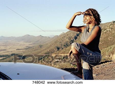 A young woman looking across an arid landscape View Large Photo Image Stock Image - A young woman looking across an arid landscape. Fotosearch