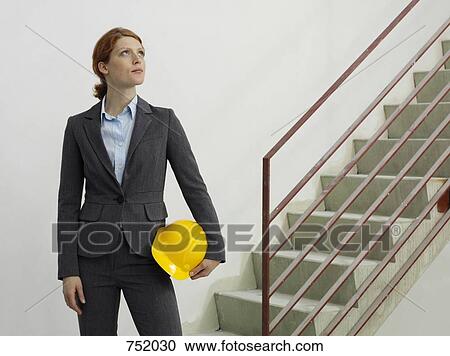 An architect reviewing work on a construction site View Large Photo Image Stock Image - An architect reviewing work on a construction site. Fotosearch