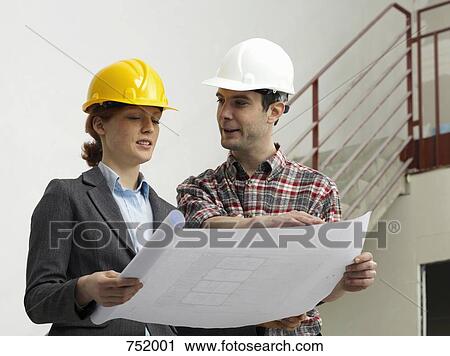 An architect speaking with a construction worker on a construction site View Large Photo Image Stock Image - An architect speaking with a construction worker on a construction site. Fotosearch