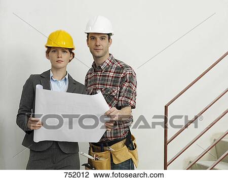 Stock Image - An architect speaking with a construction worker. Fotosearch