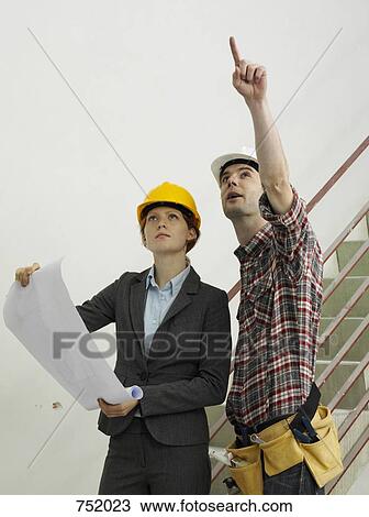 An architect speaking with a construction worker View Large Photo Image Stock Image - An architect speaking with a construction worker. Fotosearch