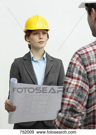 An architect speaking with a construction worker View Large Photo Image Stock Photo - An architect speaking with a construction worker. Fotosearch