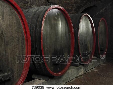 Stock Photo - Barrels of wine in a winery cellar. Fotosearch