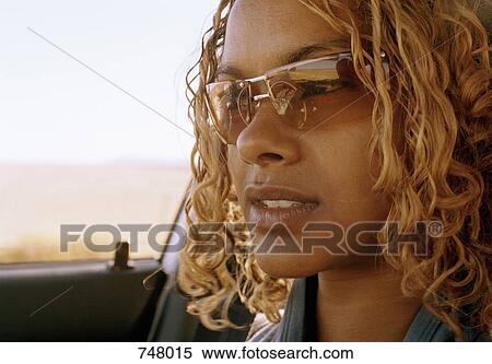 Close-up of a woman sitting in a car View Large Photo Image Stock Photography - Close-up of a woman sitting in a car. Fotosearch