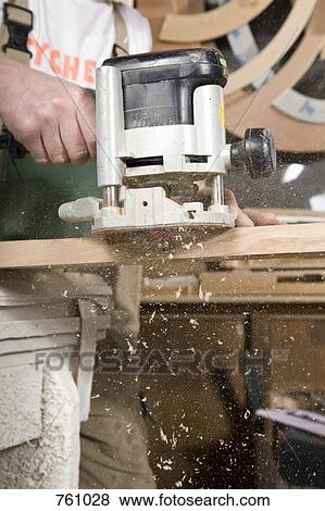 Detail of a carpenter using a sanding machine View Large Photo Image Stock Photo - Detail of a carpenter using a sanding machine. Fotosearch