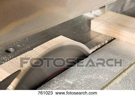 Stock Image - Detail of a circular saw cutting wood. Fotosearch
