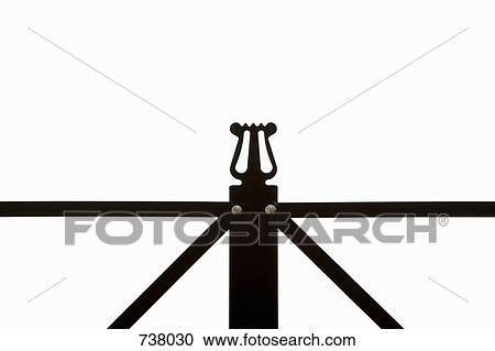 Stock Image - Extreme close-up of the lyre symbol on a musical stand. Fotosearch