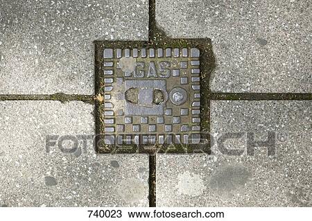 Stock Image - Gas main on a pavement. Fotosearch