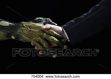 Handshake between a Monster and a businessman View Large Photo Image Picture - Handshake between a Monster and a businessman. Fotosearch