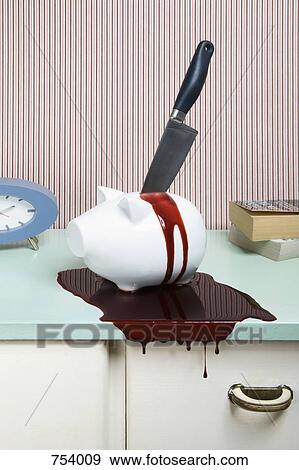 Knife stabbing a piggy bank on a dresser View Large Photo Image Stock Photo - Knife stabbing a piggy bank on a dresser. Fotosearch